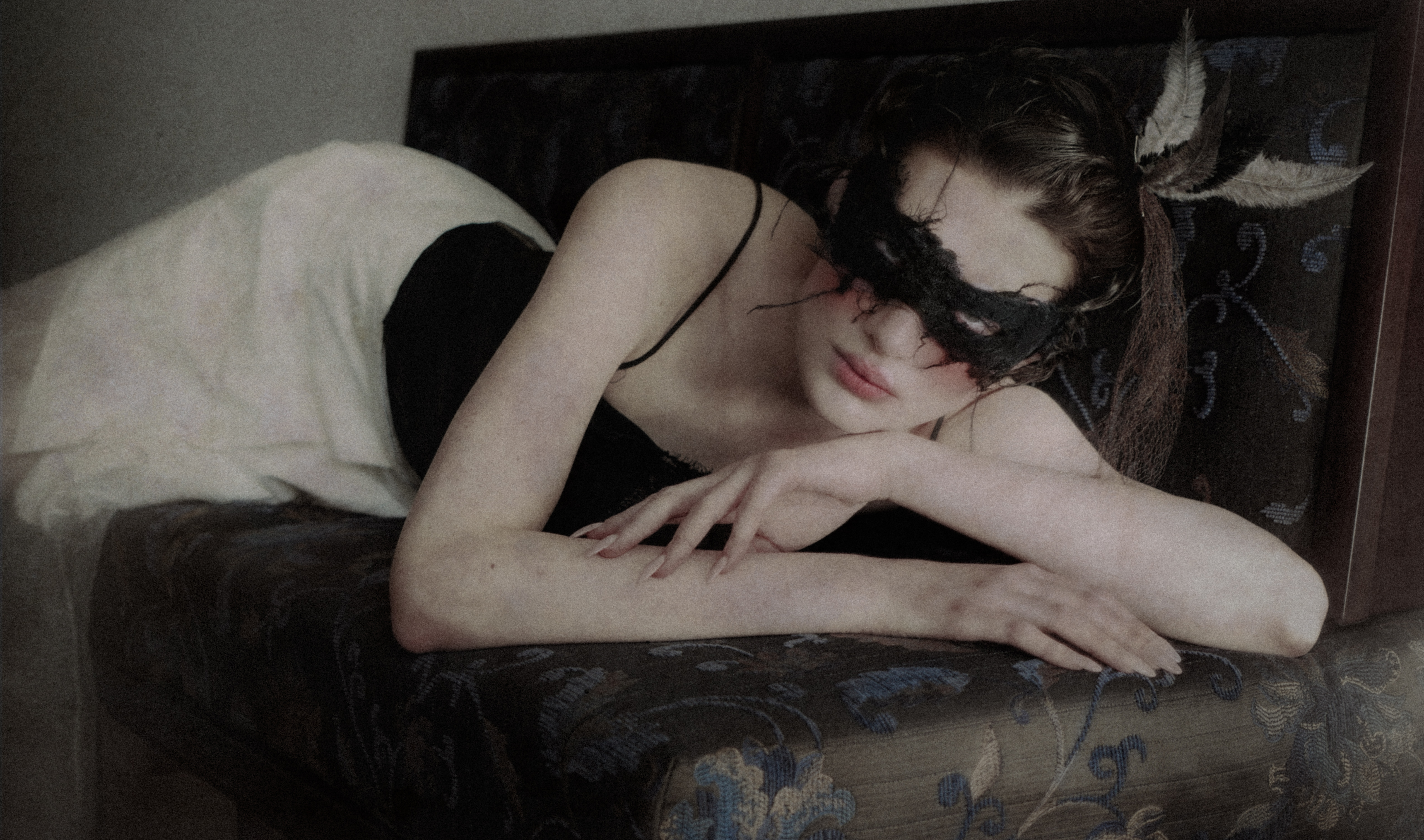 Audrey Sciorilli lying in Roman's winged mask